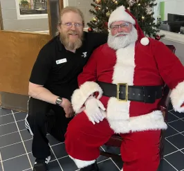 santa and a y employee posing for a picture