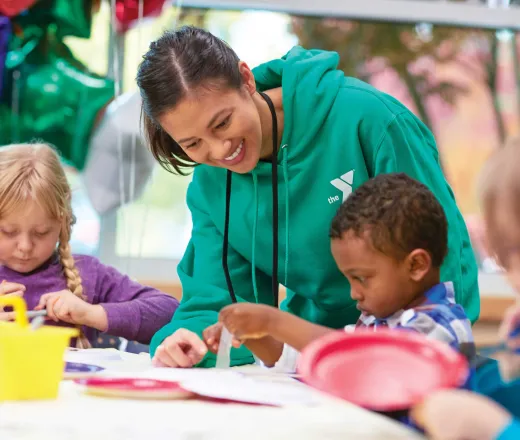 camp counselor crafting with kids