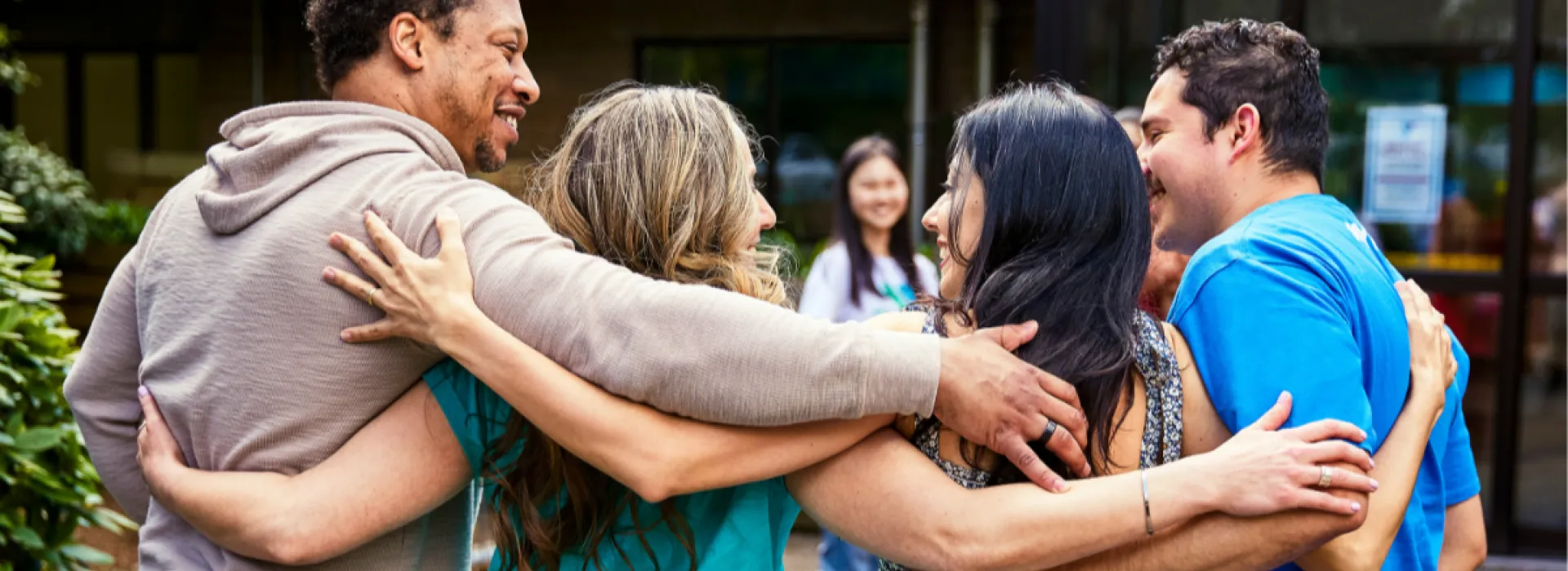 group of people arms around each other